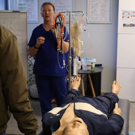 Illustrative healthcare simulation learning scene with learners and a clinical educator